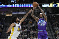 Utah Jazz guard Jordan Clarkson (00) shoots as Golden State Warriors forward Anthony Lamb (40) defends during the second half of an NBA basketball game Wednesday, Dec. 7, 2022, in Salt Lake City. (AP Photo/Rick Bowmer)