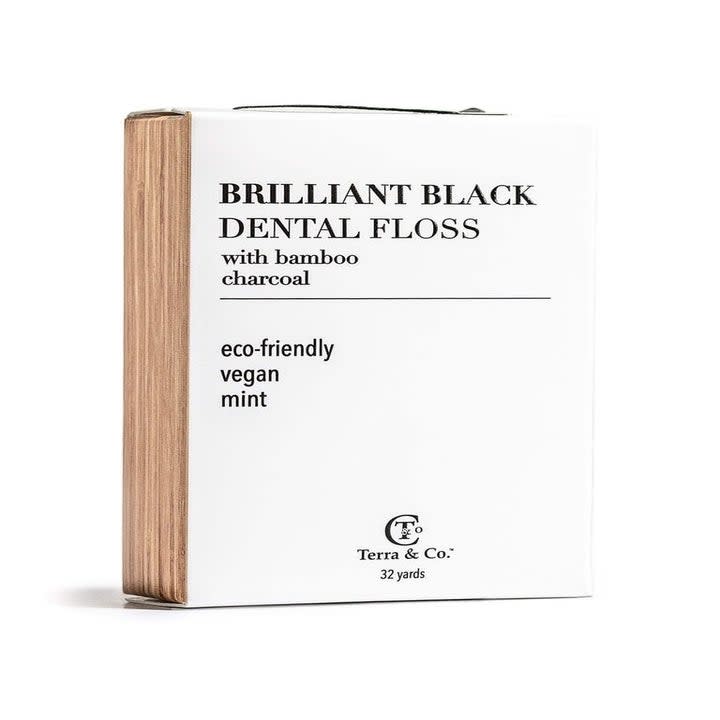 A package of black dental floss.