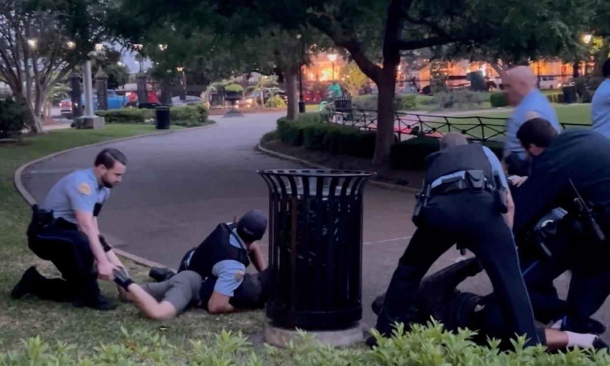 <span>In this social media video, police officers detain protesters during pro-Palestinian protest in Jackson Square.</span><span>Photograph: Drew Hawkins, Gulf States Newsroom/Reuters</span>