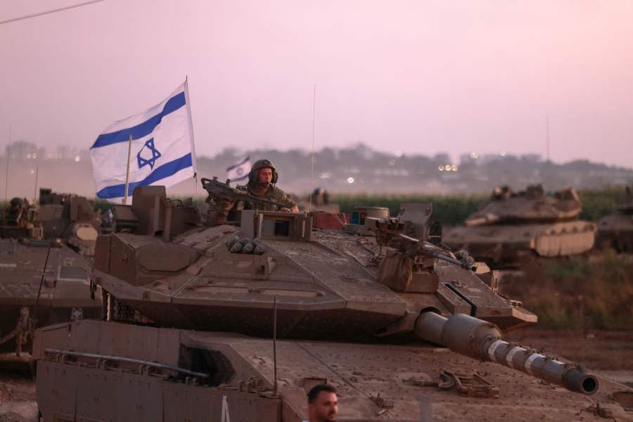 A convoy of Israeli armoured vehicles advances near the border with Gaza on October 12, 2023. Thousands of people, both Israeli and Palestinian, have died since October 7, after Palestinian Hamas militants entered Israel in a surprise attack leading Israel to declare war on Hamas in the Gaza Strip enclave. (Photo by Menahem KAHANA / AFP) (Photo by MENAHEM KAHANA/AFP via Getty Images)