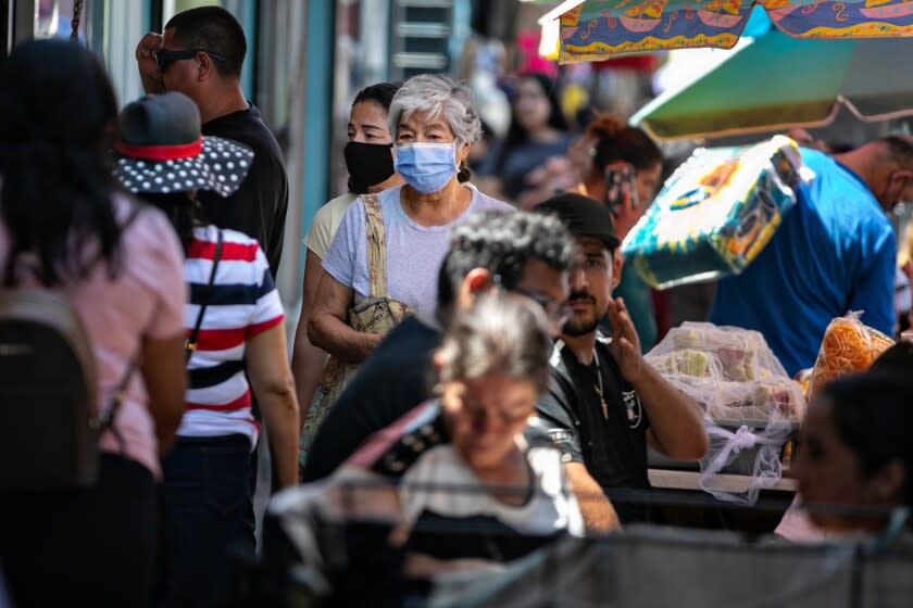 LOS ANGELES, CA - JULY 11: People shop and work in Santee Ally as covid numbers rise and masks may soon be mandatory again in LA County on Monday, July 11, 2022 in Los Angeles, CA. (Jason Armond / Los Angeles Times)