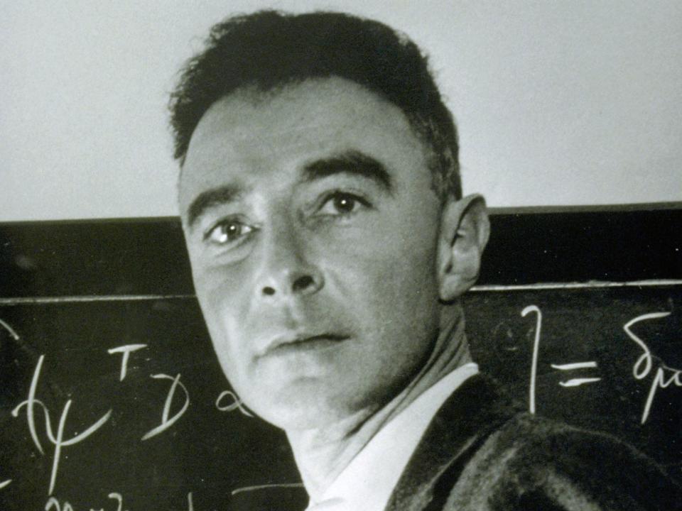 J. Robert Oppenheimer writes on a blackboard.