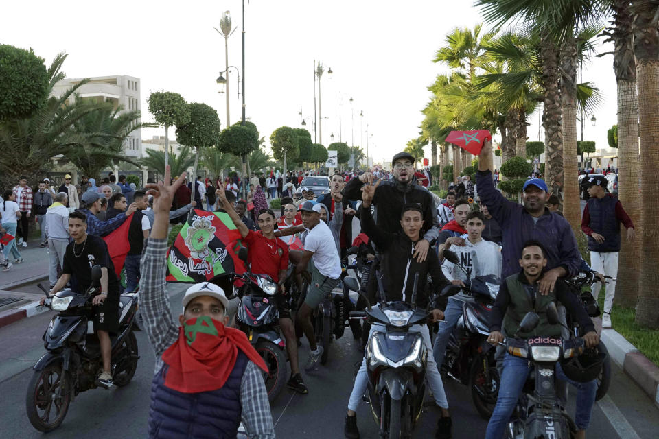 Moroccans celebrate their World Cup victory against Portugal in the Morocco-administered Western Sahara city of Laayoune, Saturday, Dec. 10, 2022. (AP Photo/Noureddine Abakchou)