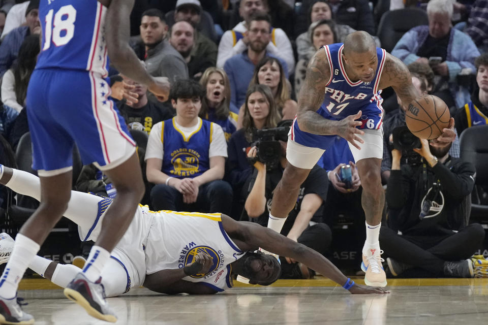 Philadelphia 76ers forward P.J. Tucker, right, grabs the ball above Golden State Warriors forward Draymond Green during the first half of an NBA basketball game in San Francisco, Friday, March 24, 2023. (AP Photo/Jeff Chiu)