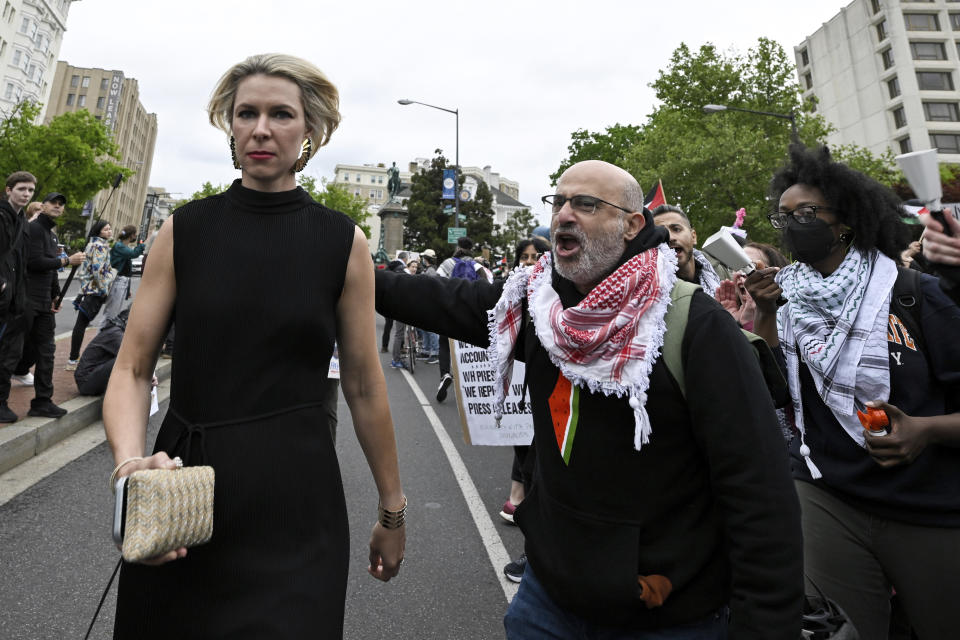 Demonstrators protest the Israel-Hamas war as a guest, left, arrives at the White House Correspondents' Association Dinner at the Washington Hilton, Saturday April 27, 2024, in Washington. (AP Photo/Terrance Williams)