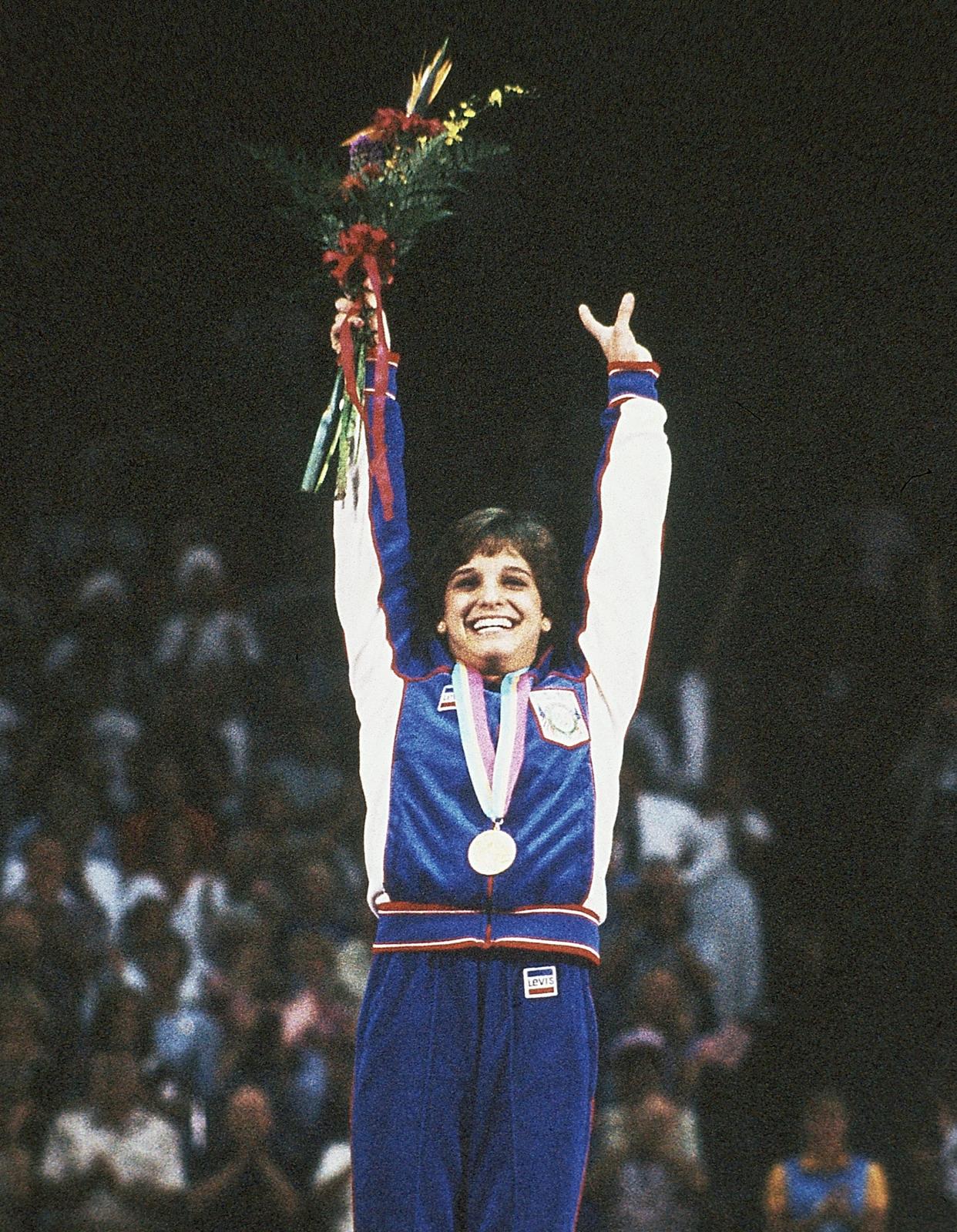 Mary Lou Retton celebrates after receiving the gold medal for winning the all-around competition at the 1984 Summer Olympics in Los Angeles.