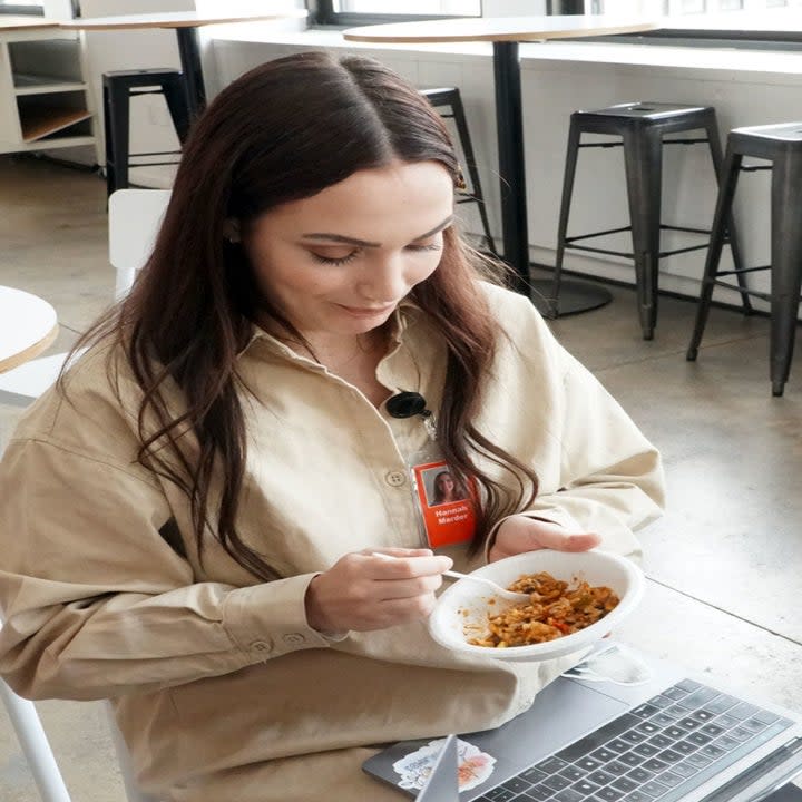 A woman eating a burrito bowl