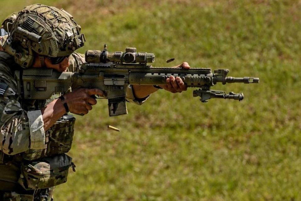 Staff Sergeant Phillip Cho firing a rifle.