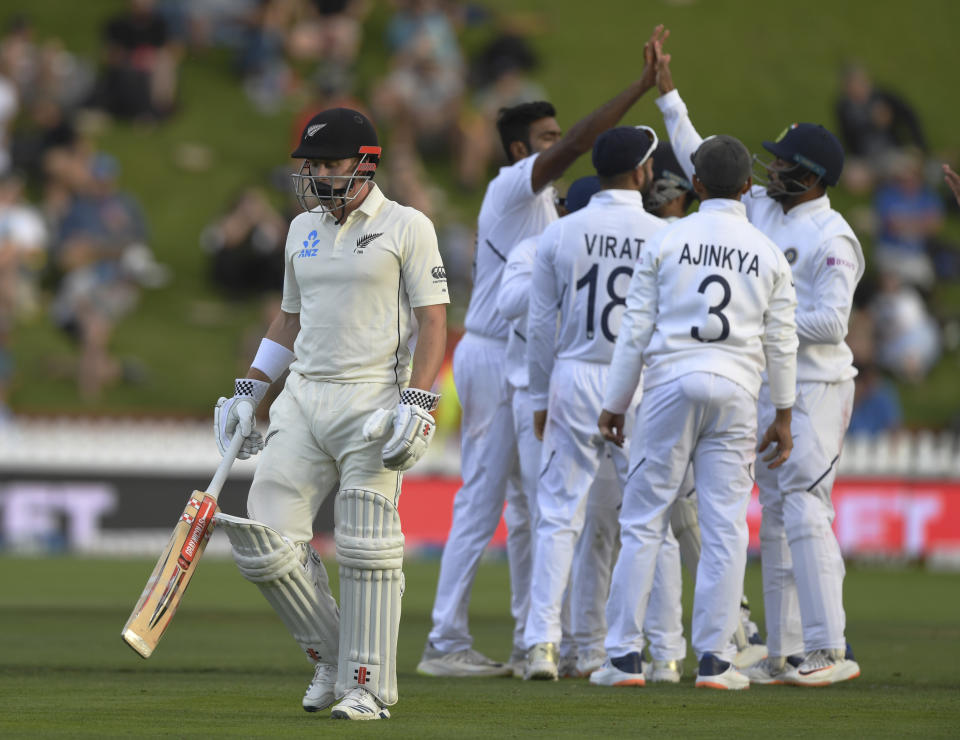 New Zealand's Henry Nicholls walks, out for 17 as India celebrate during the first cricket test between India and New Zealand at the Basin Reserve in Wellington, New Zealand, Saturday, Feb. 22, 2020. (AP Photo/Ross Setford)