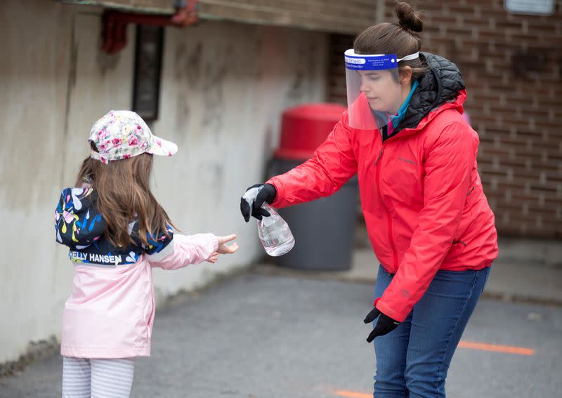 FILE PHOTO: A student has hands sanitized in the schoolyard as schools reopen outside the greater Montreal region in Saint-Jean-sur-Richelieu