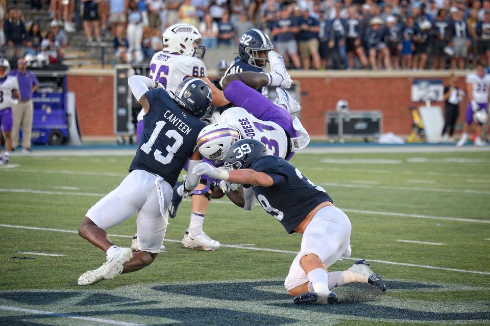 Derrick Canteen (13) and Reid Dedman 39) double up on James Madison RB Percy Agyel-Obese in the Oct. 15 game against then-No. 25 James Madison in Paulson Stadium in Statesboro. The Eagles won 45-38.