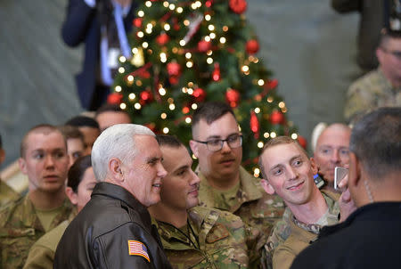 U.S. Vice President Mike Pence poses for photos with troops in a hangar at Bagram Air Field in Afghanistan on December 21, 2017. REUTERS/Mandel Ngan/Pool
