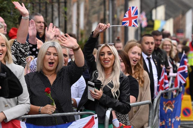 Members of the public gather outside Hillsborough Castle