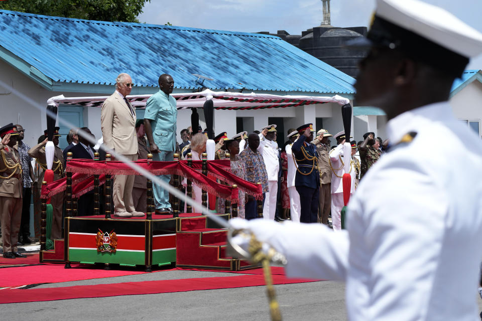 Britain's King Charles III, on podium left, and Kenya's President William Ruto, on podium right, attend a military welcome ceremony during his visit at the Mtongwe Naval Base in Mombasa, Kenya, Thursday, Nov. 2, 2023. (AP Photo/Brian Inganga, Pool)