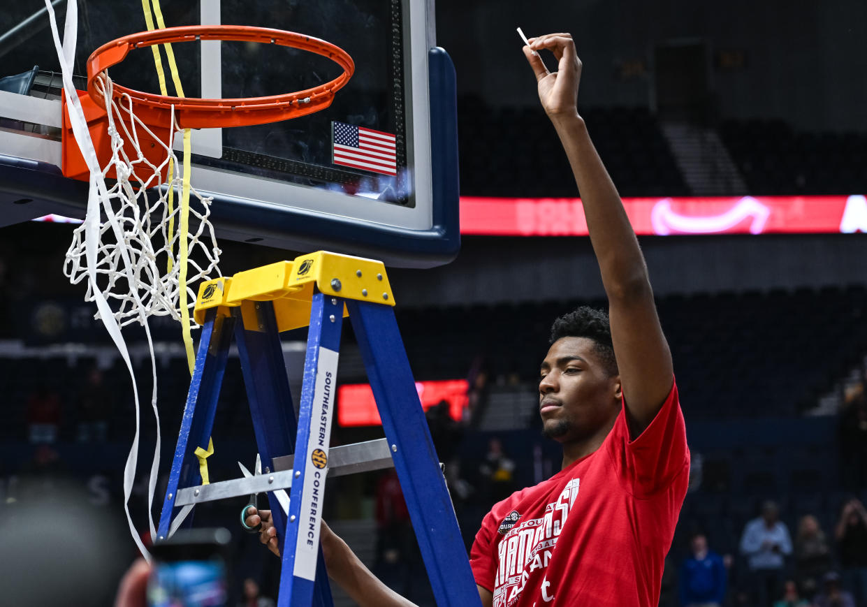 NASHVILLE, TN - MARCH 12: Alabama Crimson Tide forward Brandon Miller (24) cuts down the net after winning the SEC Mens Basketball Tournament championship game between the Alabama Crimson Tide and the Texas A&M Aggies on March 12, 2023 at Bridgestone Arena in Nashville, TN. (Photo by Bryan Lynn/Icon Sportswire via Getty Images)