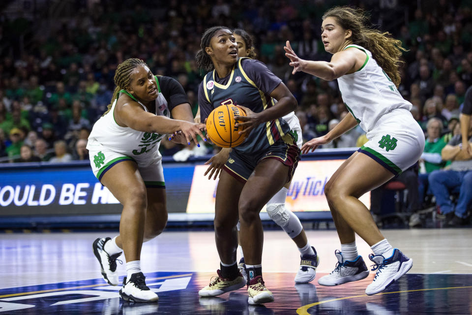 Boston College's Ava McGee (3) looks to the basket as Notre Dame's Lauren Ebo, left, and Maddy Westbeld, right, defend during the second half of an NCAA college basketball game Sunday, Jan. 1, 2023 in South Bend, Ind. (AP Photo/Michael Caterina)