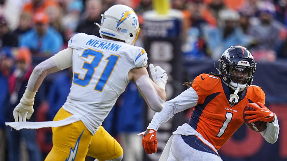 Denver Broncos cornerback Tremon Smith (1) against Los Angeles Chargers linebacker Nick Niemann (31) during the first half of an NFL football game, Sunday, Dec. 31, 2023, in Denver. (AP Photo/Jack Dempsey)