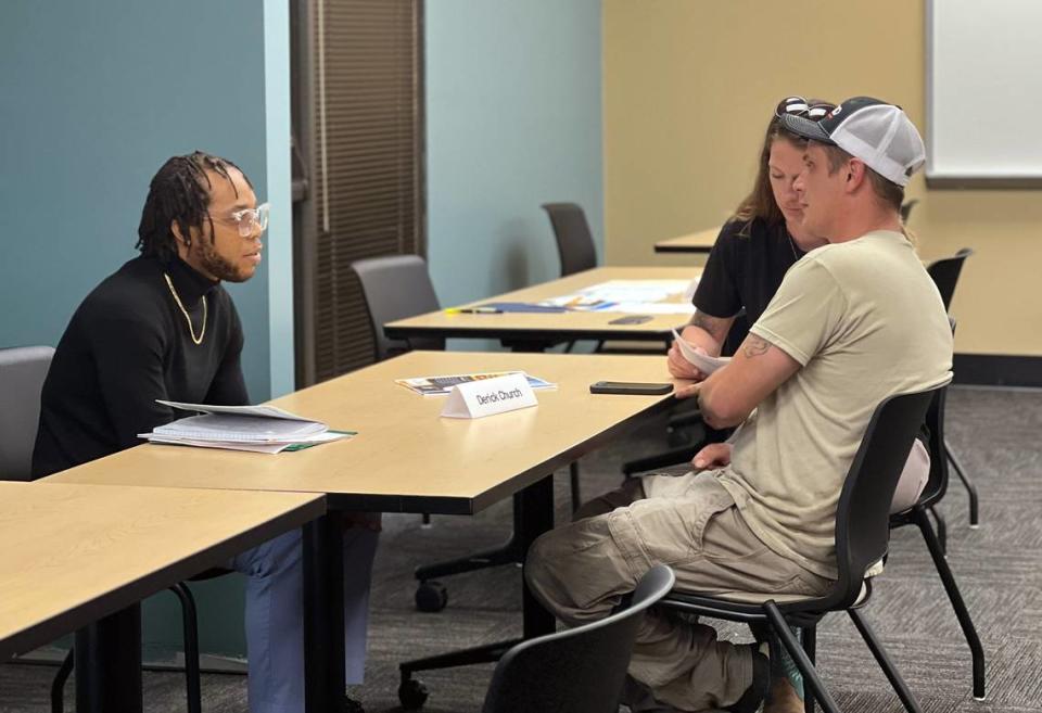 Phillip and Jennifer Hall, owners of P&J Labor Services, interview people during a career fair at SafeHouse in Columbus, Georgia.