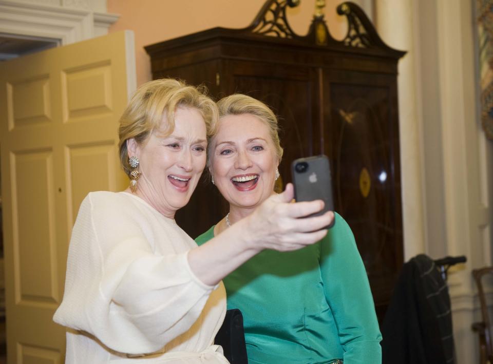 File - In this Saturday, Dec. 1, 2012, file photo Actress Meryl Streep uses her IPhone to take a photo of her and Secretary of State Hillary Rodham Clinton following the State Department Dinner for the Kennedy Center Honors gala at the State Department in Washington. "Selfie" the smartphone self-portrait has been declared word of the year for 2013 by Britain's Oxford University Press. (AP Photo/Kevin Wolf, File)