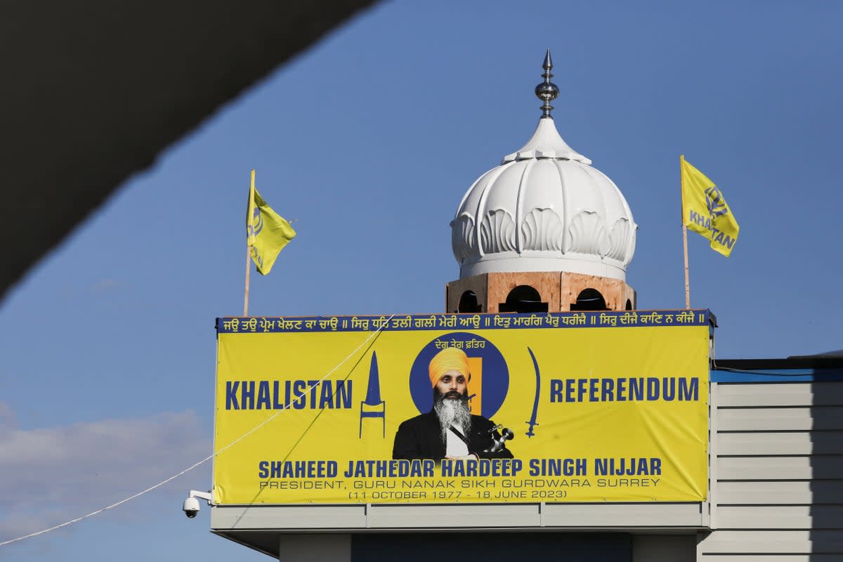 A banner with the image of Sikh leader Hardeep Singh Nijjar is seen at the Guru Nanak Sikh Gurdwara temple, site of his June 2023 killing, in Surrey (REUTERS)