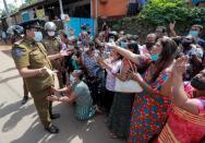 Family members of the prisoners argue with a police officer following unrest at Mahara Prison, in Colombo