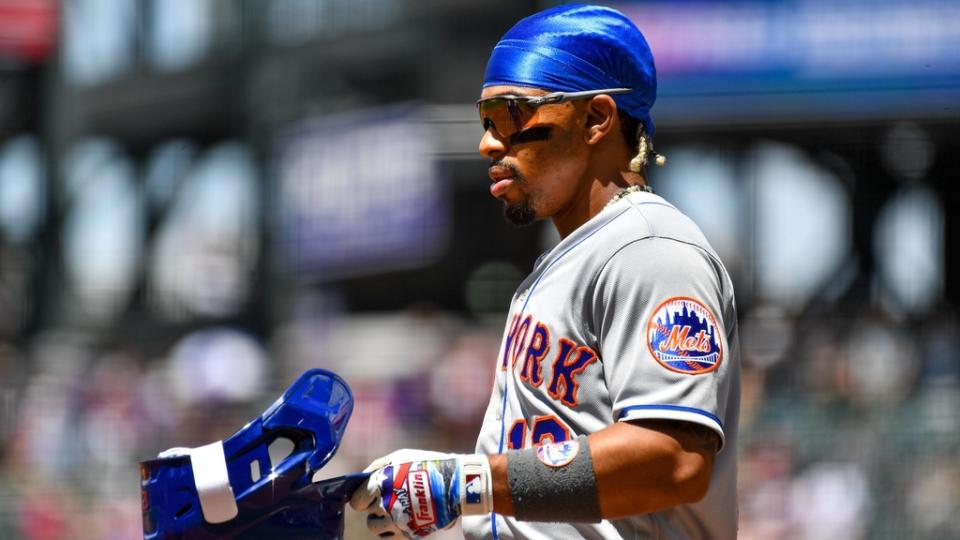 May 28, 2023;  Denver, Colorado, USA;  New York Mets shortstop Francisco Lindor (12) takes off his batting helmet after the first inning against the Colorado Rockies at Coors Field.