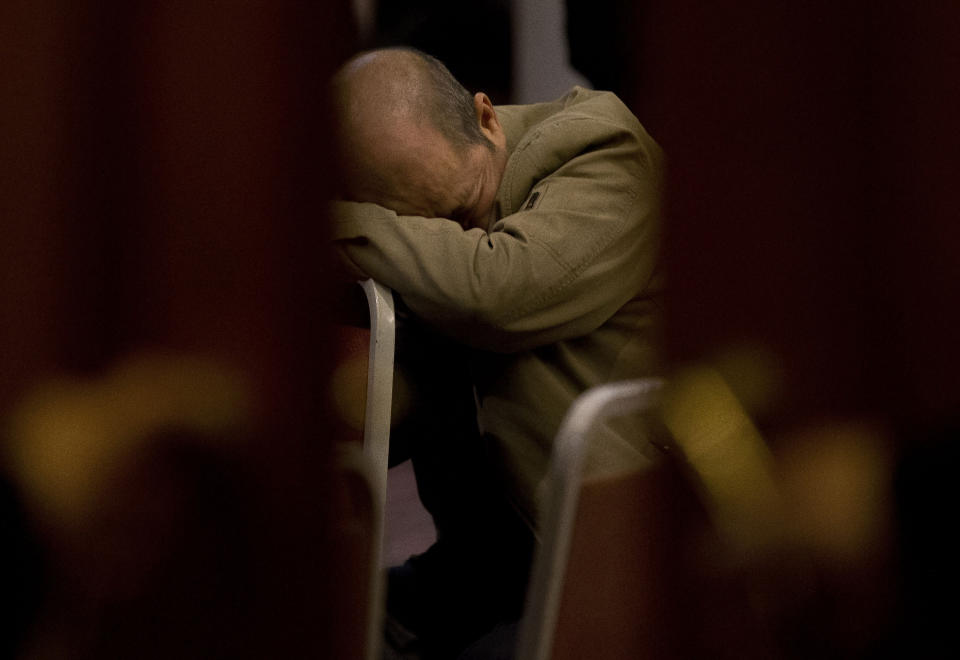 FILE - In this Tuesday, March 18, 2014 file photo, a relative of Chinese passengers aboard the missing Malaysia Airlines Flight MH370 rests on a chair as he waits for a news briefing by the Airlines' officials at a hotel ballroom in Beijing, China. The piece of information that families most wanted to hear - whether their relatives were alive or dead - has remained impossible to say with finality, creating a dilemma for the government. On March 24, it tried to address that. Malaysian Airline officials met families in Kuala Lumpur and Beijing and sent a text message to others saying “we have to assume beyond any reasonable doubt that MH370 has been lost and that none of those on board survived.” (AP Photo/Andy Wong, File)