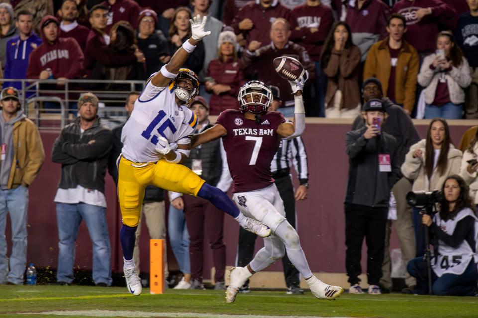 Nov 26, 2022; College Station, Texas, USA; Texas A&M Aggies wide receiver Moose Muhammad III (7) makes a one handed catch for a touchdown as LSU Tigers safety Sage Ryan (15) defends during the second half at Kyle Field. Mandatory Credit: Jerome Miron-USA TODAY Sports