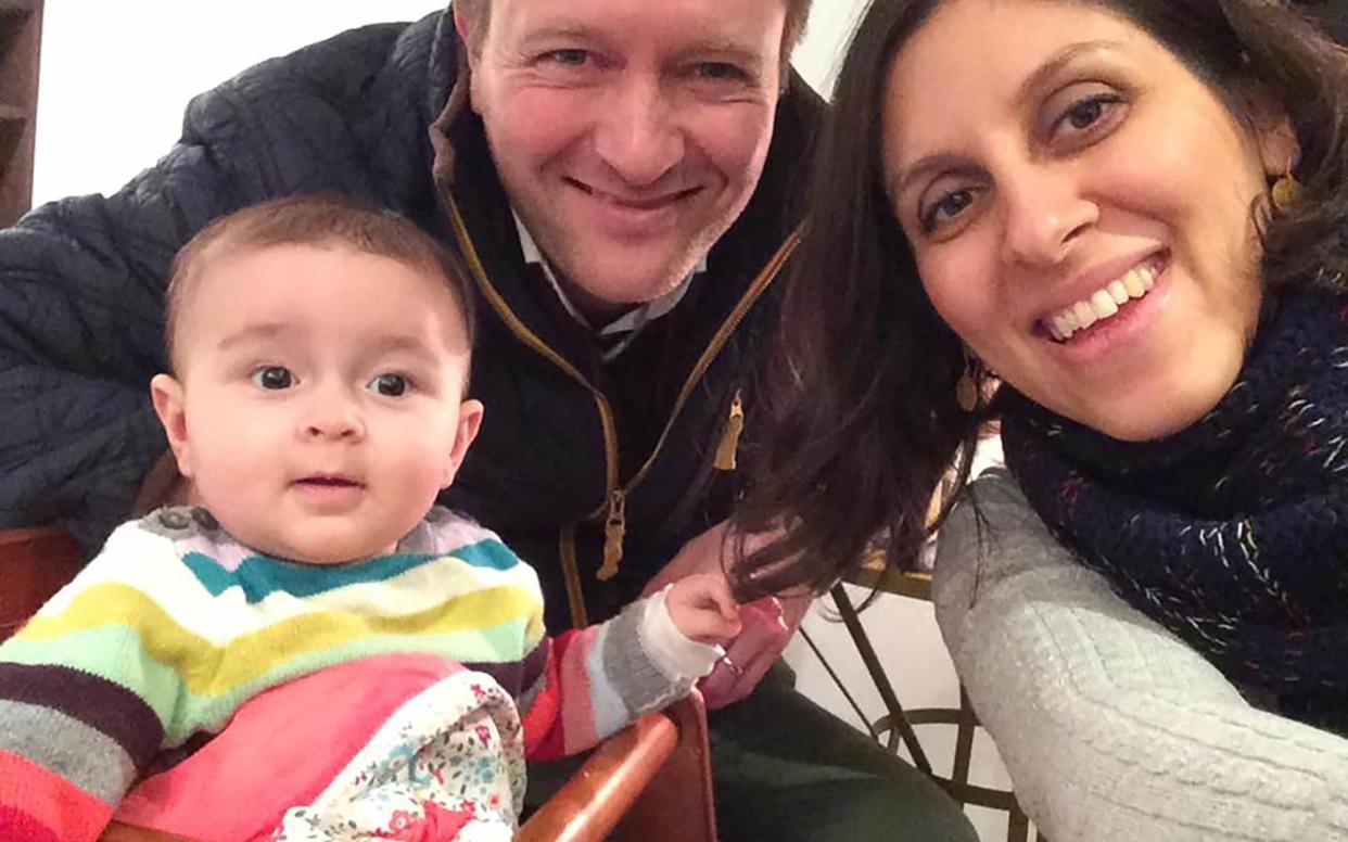 Nazanin Zaghari-Ratcliffe posing for a photograph with her husband Richard and daughter Gabriella  - AFP