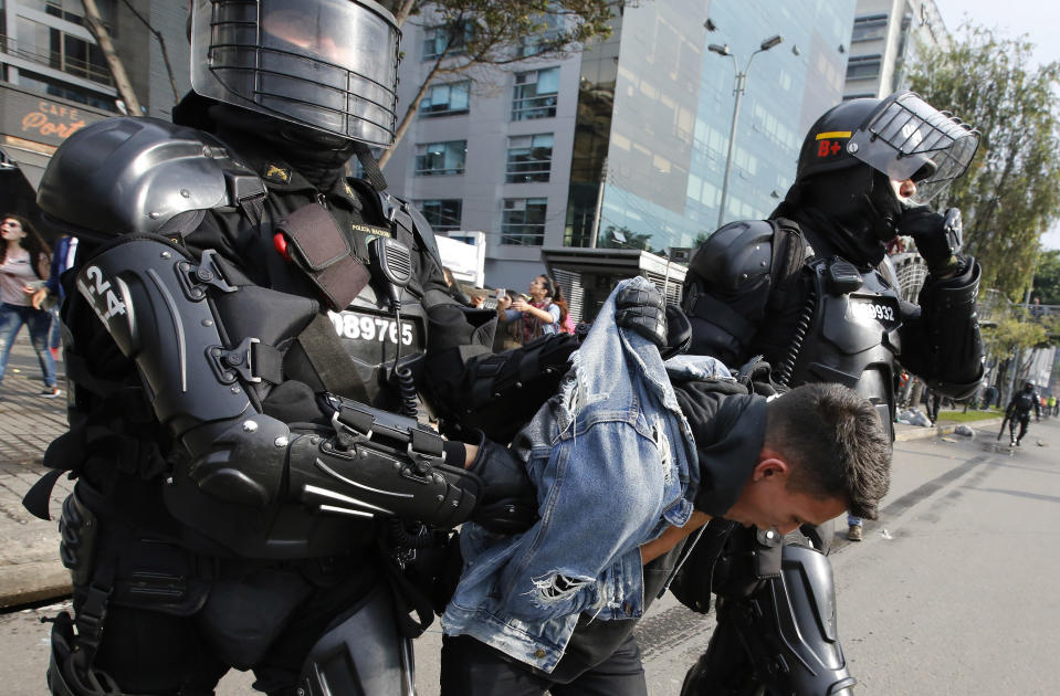 An university student is detained during a protest asking for a hike in the budget for public higher education, in Bogota, Colombia, Thursday, Nov. 15, 2018. The so-called “Pencil March” is the latest in more than a half-dozen street protests in recent months demanding the government step up funding for education. (AP Photo/Fernando Vergara)