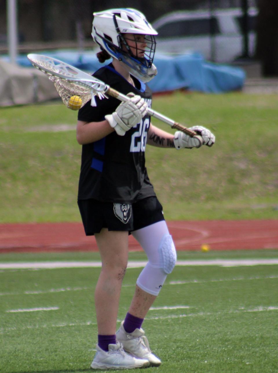 Bartram Trail goaltender Maddie Stevens (26) prepares to pass the ball downfield.