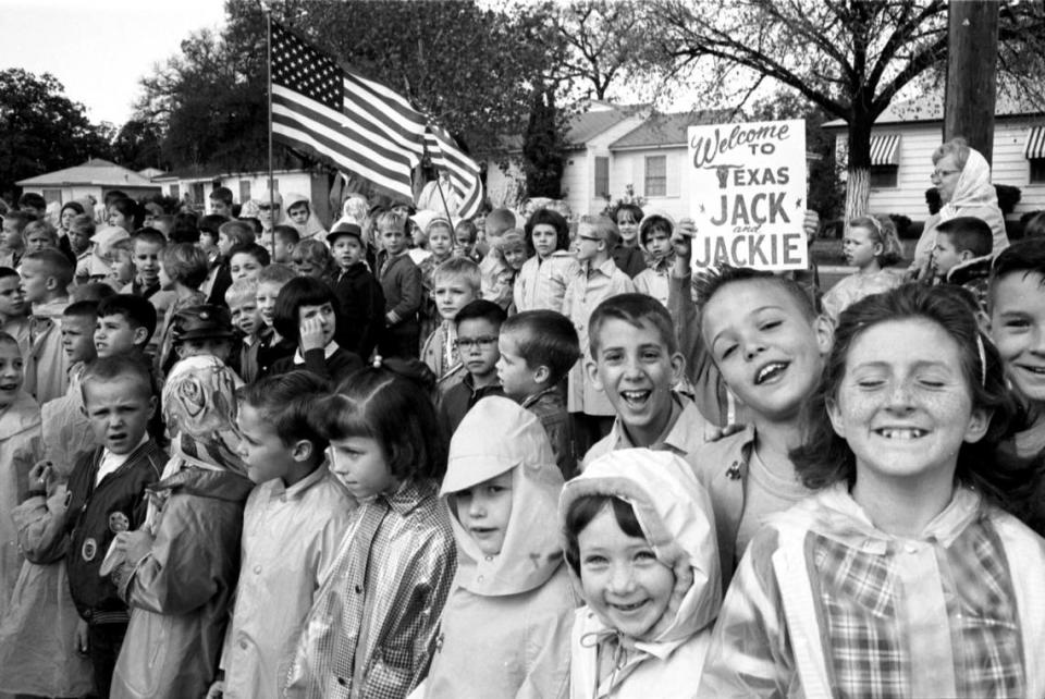 Fort Worth school children wait beside the route that President John F. Kennedy’s motorcade on the way to Carswell Air Force Base on Nov. 22, 1963.