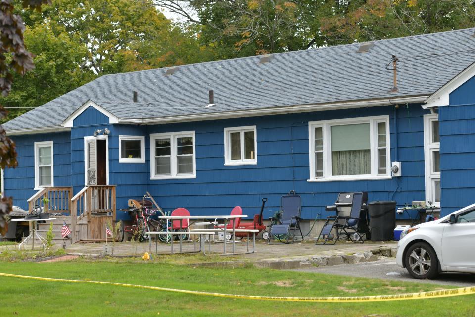 Police tape surrounds the blue ranch at 303 Millbury Ave. Sunday. Saturday a man was taken into custody and another man was discovered dead inside.