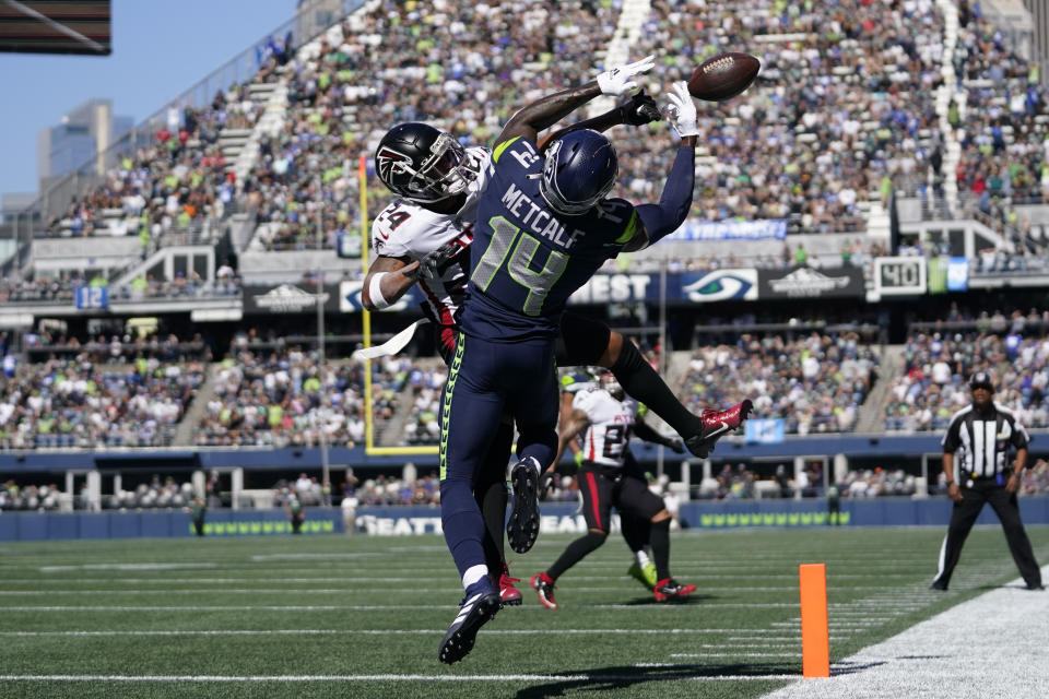 Seattle Seahawks wide receiver DK Metcalf (14) can't make the catch in the end zone as Atlanta Falcons cornerback Ka'dar Hollman defends during the first half of an NFL football game Sunday, Sept. 25, 2022, in Seattle. (AP Photo/Ashley Landis)