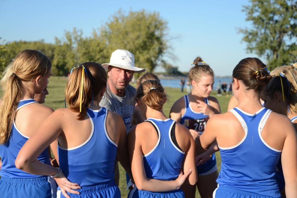 Jefferson coach Phil Speare gives his girls a pep talk before the start of the Huron League jamboree at Sterling State Park Tuesday.