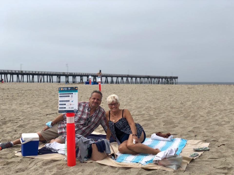 Rick Cosendino and Cathy Gerhardt of Chatsworth lounge at Port Hueneme beach on Monday, May 25, 2020. The couple were happy with the cones placed on the beach used to ensure beachgoers maintained social distancing.