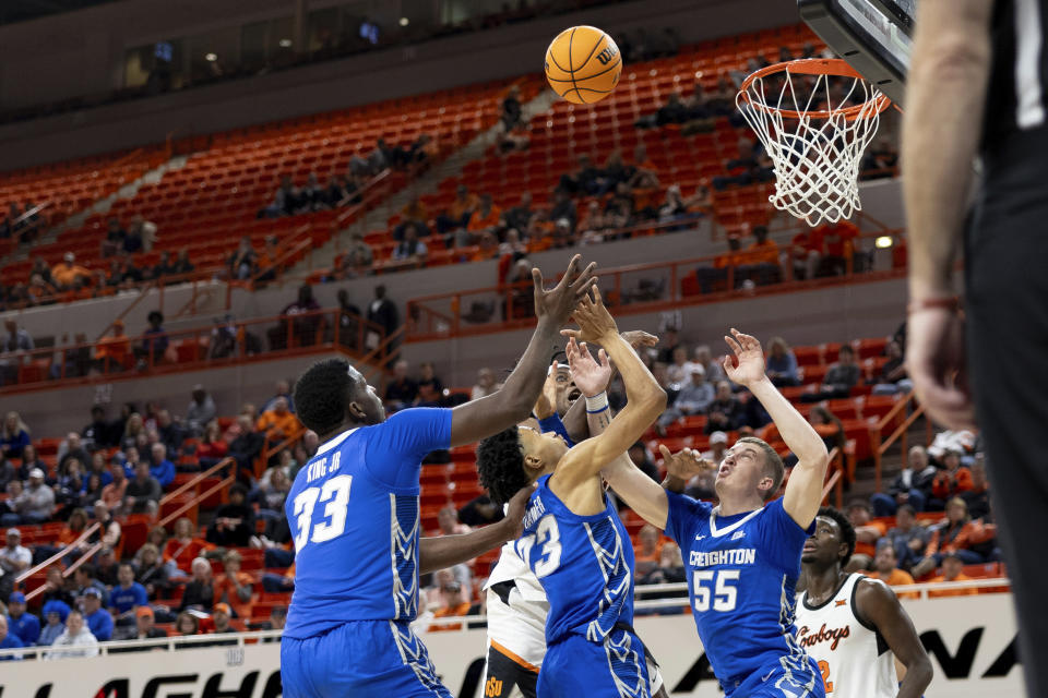 Creighton center Fredrick King (33), guard Trey Alexander and guard Baylor Scheierman (55) jump for a rebound in the second half of an NCAA college basketball game against Oklahoma State, Thursday, Nov. 30, 2023, in Stillwater, Okla. (AP Photo/Mitch Alcala)