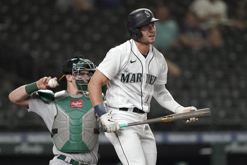 Seattle Mariners' Jarred Kelenic reacts after striking out swinging, while Oakland Athletics catcher Sean Murphy returns the ball during the eighth inning of a baseball game Tuesday, June 1, 2021, in Seattle. (AP Photo/Ted S. Warren)