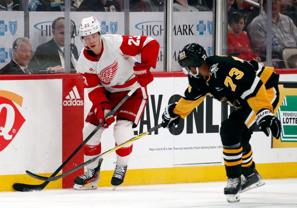 Red Wings left wing Lucas Raymond skates with the puck against Penguins defenseman Pierre-Olivier Joseph during the second period on Thursday, April 11, 2024, in Pittsburgh.