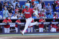 Miami Marlins' Jake Burger scores on a double by Bryan De La Cruz during the fifth inning of a baseball game against the Atlanta Braves, Saturday, April 13, 2024, in Miami. Luis Arraez and Josh Bell also scored on the play. (AP Photo/Wilfredo Lee)