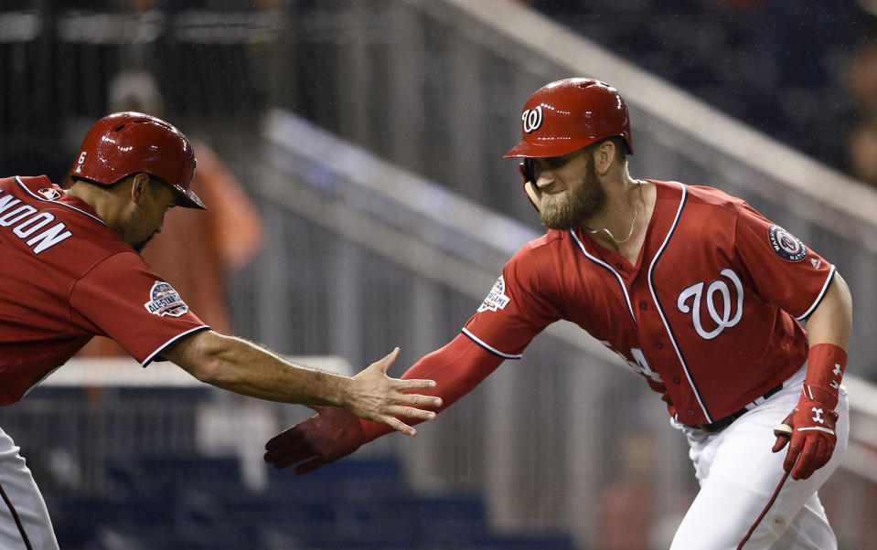 Washington Nationals' Bryce Harper, right, celebrates his two-run home run with Anthony Rendon during the seventh inning of the second baseball game of a doubleheader against the Chicago Cubs, Saturday, Sept. 8, 2018, in Washington. (AP Photo/Nick Wass)