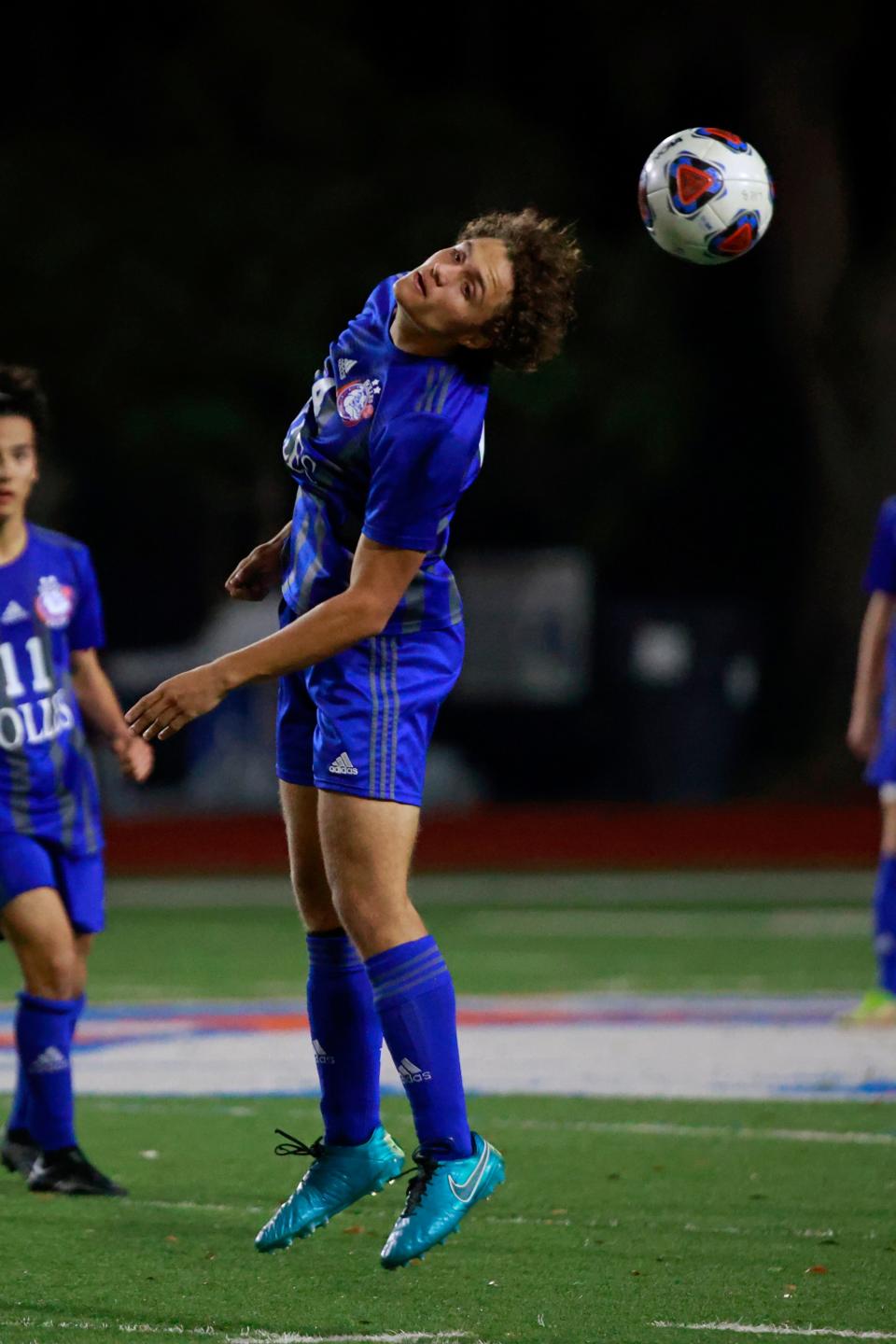 Bolles defender Donald Downer heads a ball in the 2022 regional championship. The Bulldogs enter the district tournament this week.