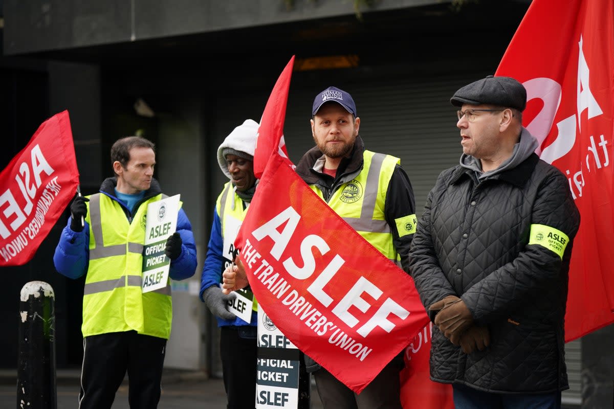 Aslef General Secretary Mick Whelan (right) joins train workers on the picket line at Euston station (PA)