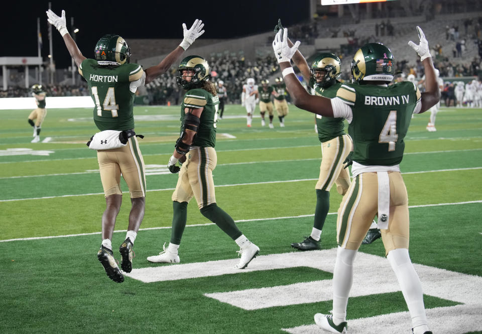 Colorado State tight end Dallin Holker, second from left, is congratulated after catching a pass for a touchdown to tie the score as wide receivers Tory Horton, left, Justus Ross-Simmons, right, and Louis Brown IV celebrate in the second half of an NCAA college football game against Boise State on Saturday, Oct. 14, 2023, in Fort Collins, Colo. (AP Photo/David Zalubowski)
