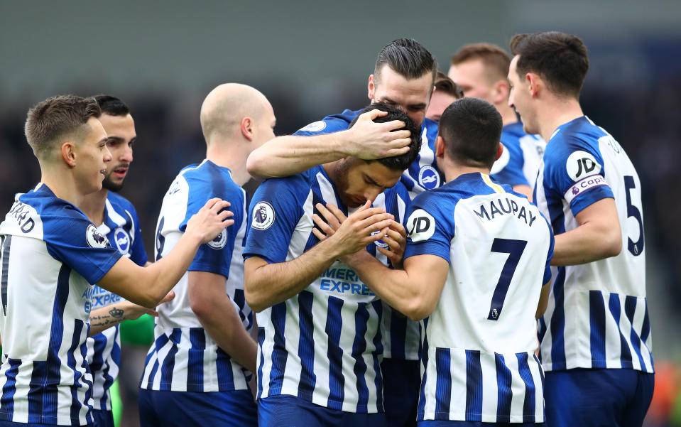 An emotional Alireza Jahanbakhsh is congratulated by teammates after scoring his first goal for the club. (Photo by Dan Istitene/Getty Images)