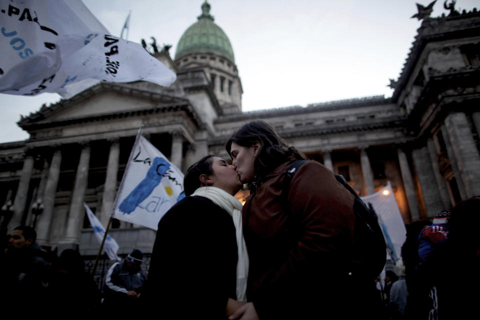 A gay couple kisses outside Argentina's congress during a rally to support a proposal to legalize same-sex marriage in Buenos Aires, Wednesday, July 14, 2010. Argentina was the first country in Latin America to legalize same-sex marriage. (AP Photo/Natacha Pisarenko)