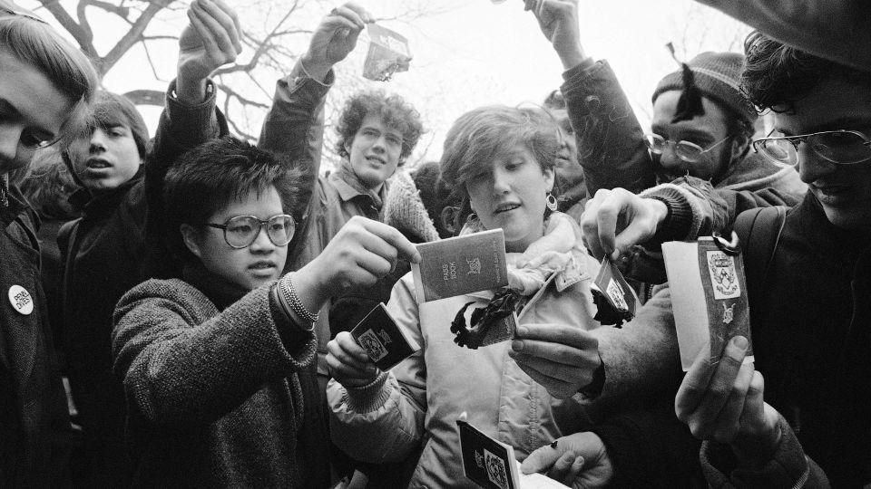 University of Pennsylvania students burn mock passbooks, like those carried by Black South Africans, at a rally to demand the university divest from South Africa's apartheid government on Feb. 10, 1986. - Amy Sancetta/AP