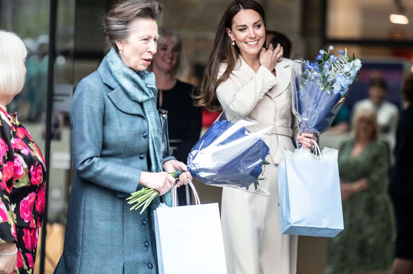 The Princess Royal and the Princess of Wales hold flowers during a joint engagement