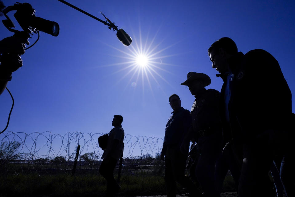 U.S. House Speaker Mike Johnson, right, walks with Texas Department of Public Safety chief Steve McCraw, second from right, near the Texas-Mexico border, Wednesday, Jan. 3, 2024, in Eagle Pass, Texas. Johnson is leading about 60 fellow Republicans in Congress on a visit to the Mexican border. Their trip comes as they are demanding hard-line immigration policies in exchange for backing President Joe Biden's emergency wartime funding request for Ukraine. (AP Photo/Eric Gay)