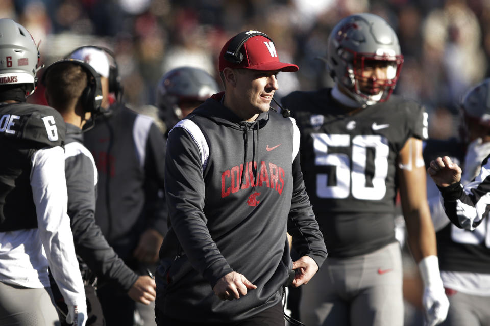 Washington State head coach Jake Dickert, center, walks on the field during a break in play in the first half of an NCAA college football game against Arizona State, Saturday, Nov. 12, 2022, in Pullman, Wash. (AP Photo/Young Kwak)